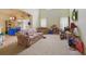 Bright living room with high ceilings, tile flooring, and large windows, offering ample natural light at 1305 Rebecca Dr, Haines City, FL 33844