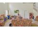 Bright living room with high ceilings, tile flooring, and large windows, offering ample natural light at 1305 Rebecca Dr, Haines City, FL 33844