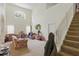 Bright living room with high ceilings, staircase, and large window, offering ample natural light at 1305 Rebecca Dr, Haines City, FL 33844