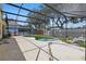 Screened in patio features an in-ground pool, as well as outdoor furniture at 1305 Rebecca Dr, Haines City, FL 33844