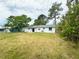 Rear exterior view of the home showcasing the spacious backyard at 1355 Dexter E Dr, Port Orange, FL 32129