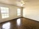 An empty bedroom with tile floors, two windows and a ceiling fan at 1355 Dexter E Dr, Port Orange, FL 32129
