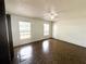 An empty bedroom with two windows provides ample light, complimented by the overhead ceiling fan at 1355 Dexter E Dr, Port Orange, FL 32129