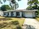 Single story home with a front yard, archway, and attached one-car garage at 1355 Dexter E Dr, Port Orange, FL 32129