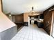 Open layout kitchen with white tile floors, wood paneling, and bar seating at 1355 Dexter E Dr, Port Orange, FL 32129