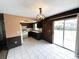 A spacious kitchen with a dining nook, dark wood cabinets, and access to the backyard at 1355 Dexter E Dr, Port Orange, FL 32129