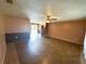 Spacious living room with tile flooring, ceiling fan and staircase at 1355 Dexter E Dr, Port Orange, FL 32129