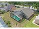 Overhead shot of a home featuring a screened-in pool, a patio area, and manicured landscaping in the backyard at 1956 Southern Dunes Blvd, Haines City, FL 33844
