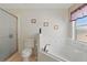 Bright bathroom featuring a bathtub, toilet, and decorative touches at 1956 Southern Dunes Blvd, Haines City, FL 33844