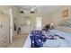 Spacious bedroom featuring light-colored furniture, including a dresser, armoire, and a king-sized bed at 1956 Southern Dunes Blvd, Haines City, FL 33844