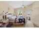 Cozy bedroom with natural light, ceiling fan and light colored furniture at 1956 Southern Dunes Blvd, Haines City, FL 33844