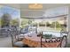 Cozy breakfast nook with a table and chairs, and a view through the windows to the screened-in pool at 1956 Southern Dunes Blvd, Haines City, FL 33844