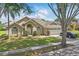 Charming single-story home featuring well-kept landscaping and an attached two-car garage on a sunny day at 1956 Southern Dunes Blvd, Haines City, FL 33844