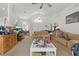 Inviting living room with high ceilings, neutral carpet, and large windows providing plenty of light at 1956 Southern Dunes Blvd, Haines City, FL 33844