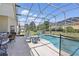 Relax by the pool and enjoy the screened-in lanai featuring ample seating, table, and chairs for outdoor dining at 1956 Southern Dunes Blvd, Haines City, FL 33844