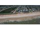 Drone's-eye view showcases beach, ocean, and neighborhood's proximity to the water at 3000 Ocean Shore Blvd # 150, Ormond Beach, FL 32176