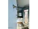 Small, modern bathroom with a brushed metal three hook rack, white vanity and tile shower with a glass door at 3000 Ocean Shore Blvd # 150, Ormond Beach, FL 32176