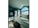 Bright, stylish primary bathroom featuring a soaking tub, tile surround, separate shower, and a large arched window at 3000 Ocean Shore Blvd # 150, Ormond Beach, FL 32176