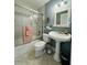 Cozy bathroom with combined shower and tub, pedestal sink and decorative elements at 3000 Ocean Shore Blvd # 150, Ormond Beach, FL 32176