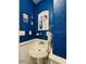 Nautical-themed bathroom with sink, anchor decor, and wall mirror at 3000 Ocean Shore Blvd # 150, Ormond Beach, FL 32176