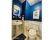 Nautical-themed bathroom with pedestal sink, toilet, and coastal decorations at 3000 Ocean Shore Blvd # 150, Ormond Beach, FL 32176