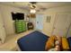 Relaxing bedroom with TV, dresser, and ceiling fan, offering a comfortable retreat at 3000 Ocean Shore Blvd # 150, Ormond Beach, FL 32176