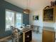 Open dining area with modern lighting and neutral decor complements the adjacent space at 3000 Ocean Shore Blvd # 150, Ormond Beach, FL 32176