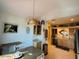 Cozy dining area with beach artwork and view into modern kitchen at 3000 Ocean Shore Blvd # 150, Ormond Beach, FL 32176