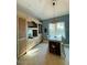 Open dining area features built-in cabinets, a view of the outdoors and a modern light fixture at 3000 Ocean Shore Blvd # 150, Ormond Beach, FL 32176