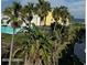 Colorful beach condos surrounded by lush tropical palm trees and plants at 3000 Ocean Shore Blvd # 150, Ormond Beach, FL 32176