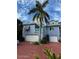 Coastal three-story home with colorful exterior, two-car garage, and lush tropical landscaping at 3000 Ocean Shore Blvd # 150, Ormond Beach, FL 32176
