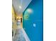 Bright hallway with beach-themed decor and a view of the beach from the doorway at 3000 Ocean Shore Blvd # 150, Ormond Beach, FL 32176