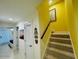 Hallway with stairs and coastal decorations at 3000 Ocean Shore Blvd # 150, Ormond Beach, FL 32176