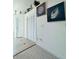 Light and airy hallway with neutral tones, beach themed wall decor, and convenient closet space at 3000 Ocean Shore Blvd # 150, Ormond Beach, FL 32176