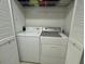 Efficient laundry area featuring a washer and dryer with storage at 3000 Ocean Shore Blvd # 150, Ormond Beach, FL 32176