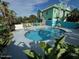 A pool surrounded by colorful homes and lush landscaping at 3000 Ocean Shore Blvd # 150, Ormond Beach, FL 32176