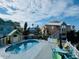 Community pool with several homes around it at 3000 Ocean Shore Blvd # 150, Ormond Beach, FL 32176
