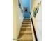 Carpeted stairwell leads to upper level; artwork on walls adds a decorative touch at 3000 Ocean Shore Blvd # 150, Ormond Beach, FL 32176