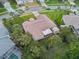 Aerial view showcasing the home's layout, lush landscaping, screened in porch and proximity to neighboring properties at 4622 Secret River Trl, Port Orange, FL 32129