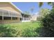 Spacious backyard featuring well-kept lawn, mature landscaping, and a screened in porch at 4622 Secret River Trl, Port Orange, FL 32129