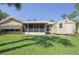 Well-maintained backyard showcasing the home's back exterior, screened-in porch and storage shed at 4622 Secret River Trl, Port Orange, FL 32129