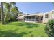 Expansive backyard featuring a lush lawn, a screened-in porch and a shed at 4622 Secret River Trl, Port Orange, FL 32129