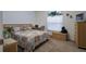 Comfortable bedroom with a bed, wicker accents, and a window for natural light at 4622 Secret River Trl, Port Orange, FL 32129
