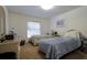 Bedroom with twin beds, wicker furniture, and natural light from a window, creating a cozy atmosphere at 4622 Secret River Trl, Port Orange, FL 32129