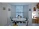 Cozy dining area featuring a round table, comfortable chairs, and natural light from the bay window at 4622 Secret River Trl, Port Orange, FL 32129