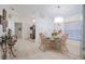 Bright dining area with tile flooring, a glass-top table, and classic furnishings under a chandelier at 4622 Secret River Trl, Port Orange, FL 32129