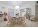 Cozy dining room with a glass table, wicker chairs, and display cabinet, bathed in natural light at 4622 Secret River Trl, Port Orange, FL 32129