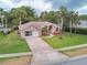 Exterior aerial view of a well-maintained home with a spacious driveway and lush landscaping at 4622 Secret River Trl, Port Orange, FL 32129
