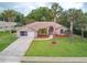 Beautiful brick home with a well-manicured lawn and mature palm trees adding to the curb appeal at 4622 Secret River Trl, Port Orange, FL 32129