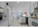 Efficient kitchen featuring white cabinets, black appliances, and ample counter space for meal preparation at 4622 Secret River Trl, Port Orange, FL 32129